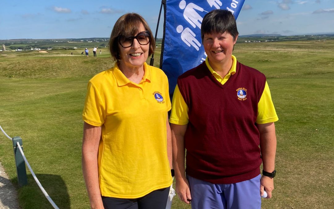 2 lady golfers wearing yellow tops