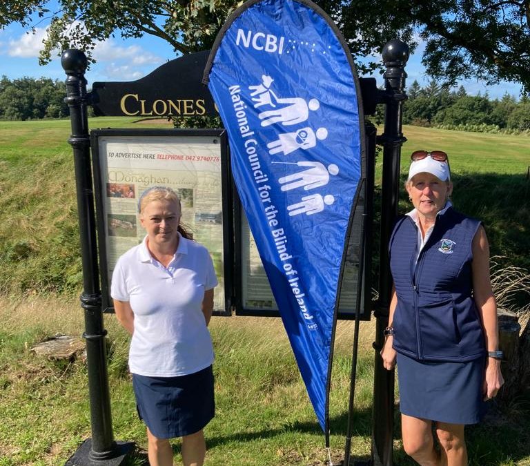 2 lady golfers in front of blue NCBI sign